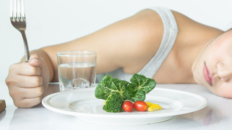 Woman with small plate of vegetables 