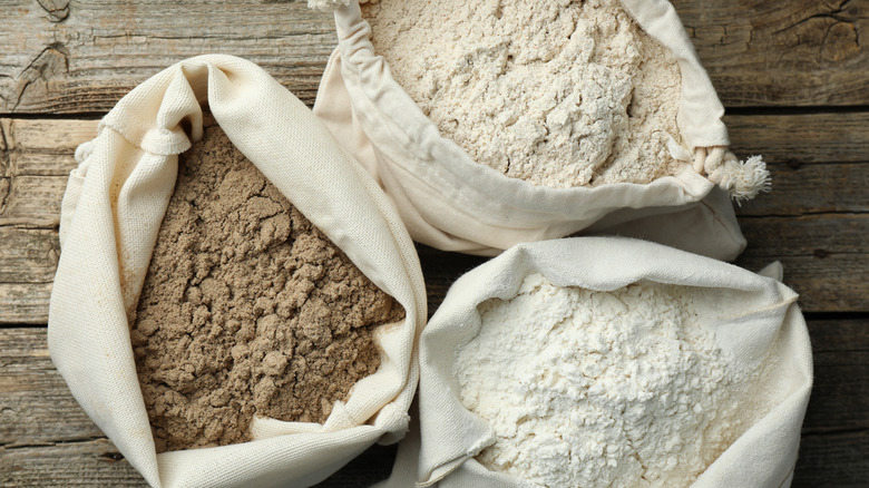 Three sacks containing different types of flour