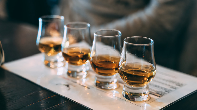 Four glasses in a whiskey flight