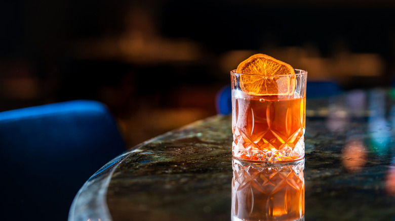 Whiskey cocktail with dried orange slice