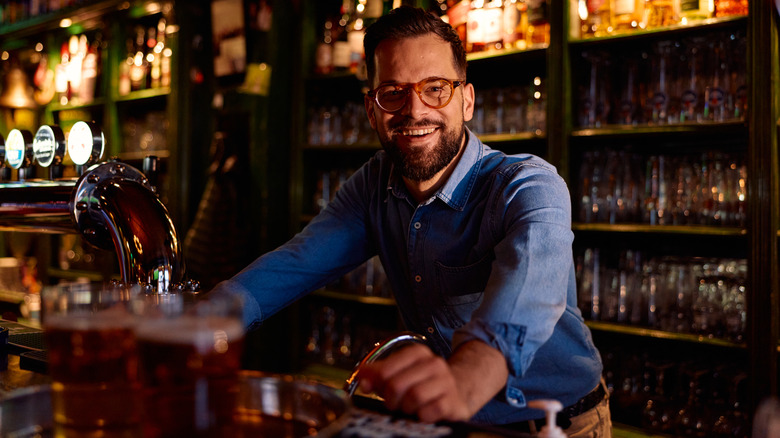 Smiling bartender waiting for order