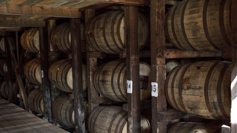 Whiskey barrels aging on racks