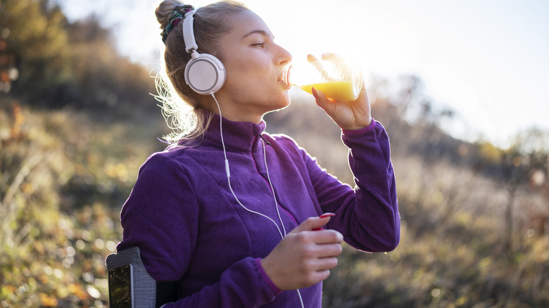 Woman drinking a glass of orange juice