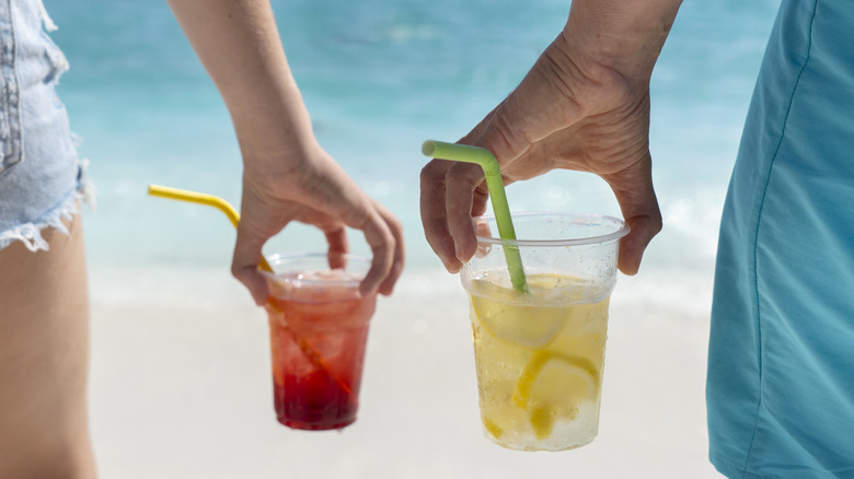 Man and woman holding lemonade
