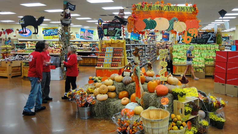 An autumn display with pumpkins inside a Trader Joe's grocery store