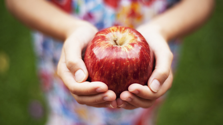 Woman holding an apple