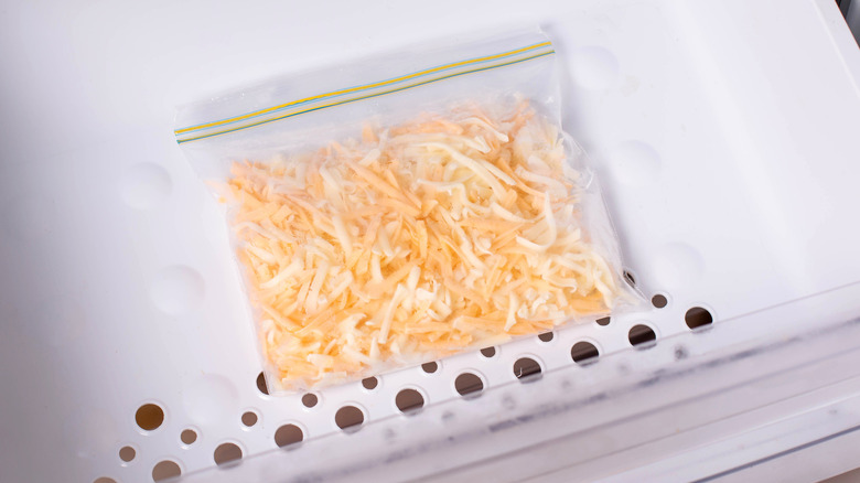 Bag of frozen grated cheese in a freezer