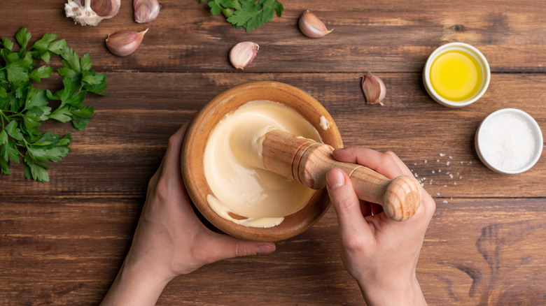 making aioli in mortar and pestle