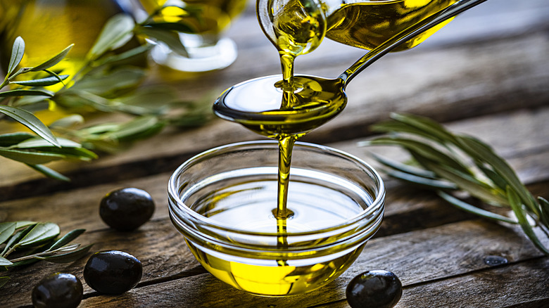 Pouring olive oil into bowl