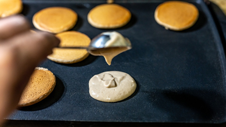 pancakes cooking on a griddle