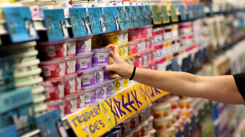 shopper in Trader Joes yogurt section