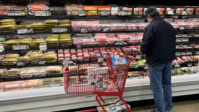 Shopper choosing Trader Joes meats
