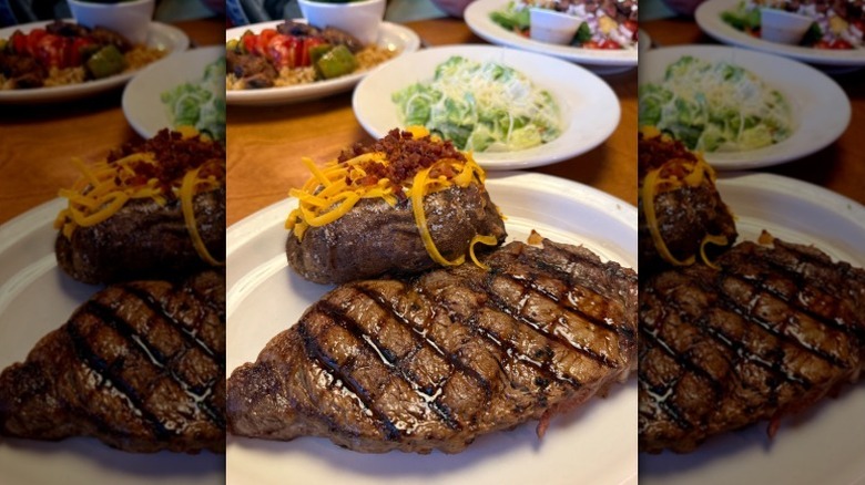 Texas Roadhouse steak and loaded baked potato on a white plate