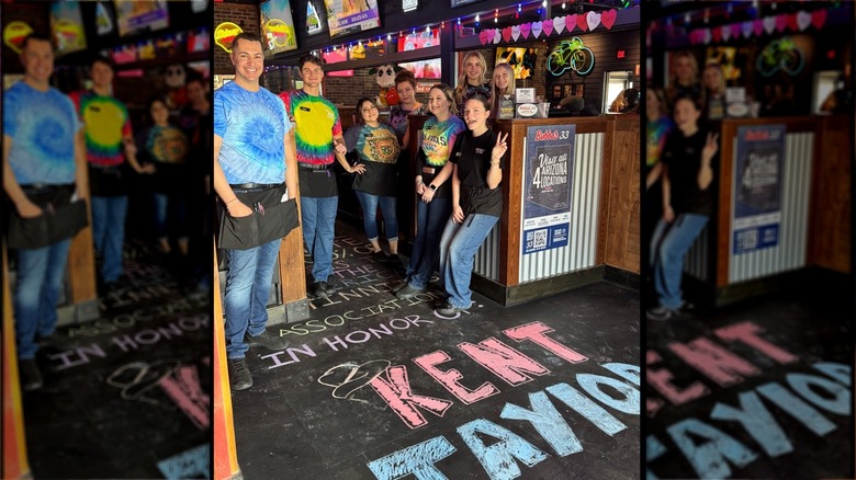 Texas Roadhouse employees standing on floor with a fundraiser promotion written in chalk