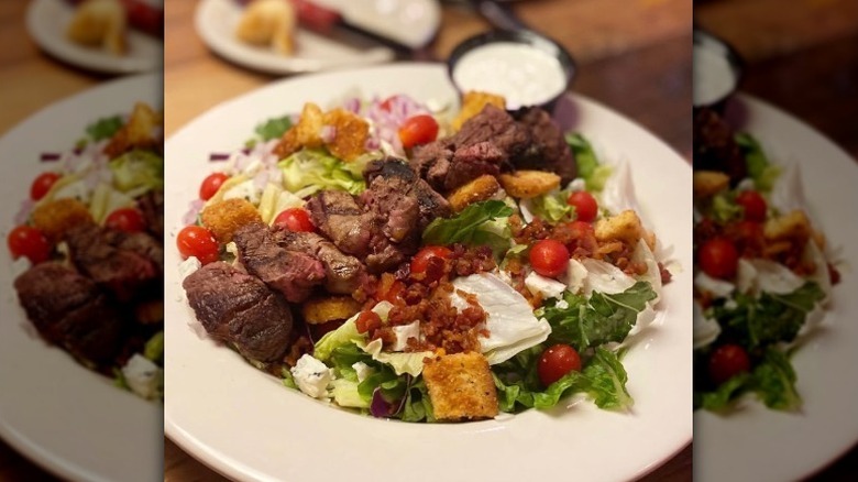 Texas Roadhouse steak salad in a white dish