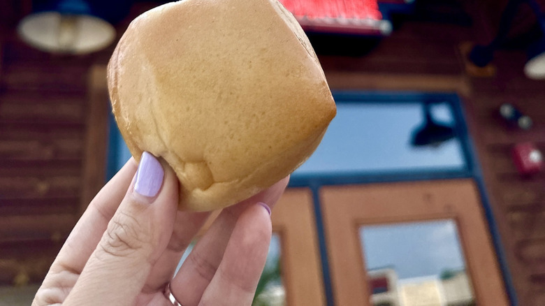 Hand holding a roll outside of Texas Roadhouse