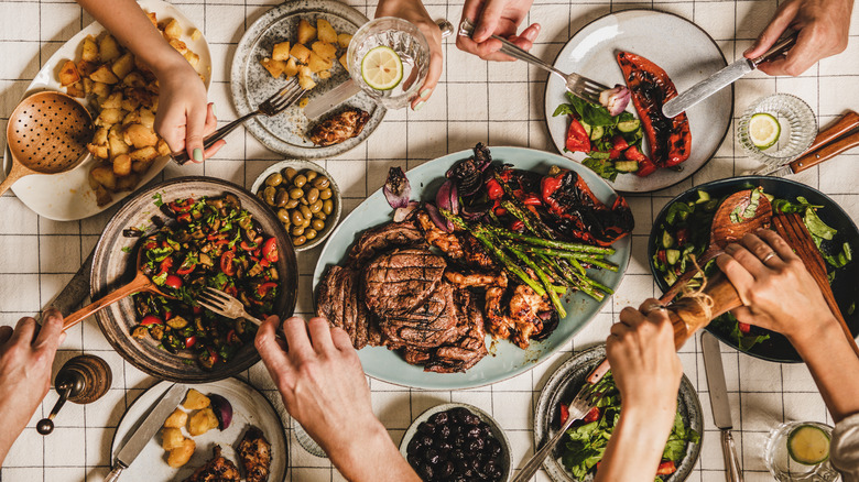 Family gathered around food on a table