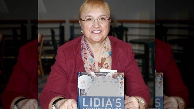 Lidia Bastianich holding her cookbook