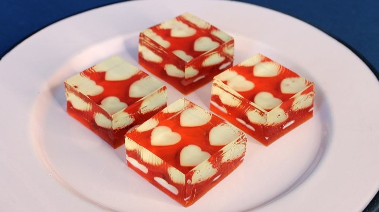Red cubes of Jell-O with white hearts inside.