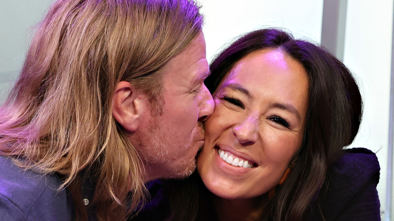 Chip and Joanna Gaines close-up kissing on cheek