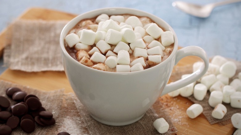 A mug of hot chocolate topped with mini marshmallows.
