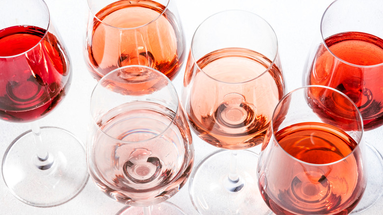 Glasses of wine on white background