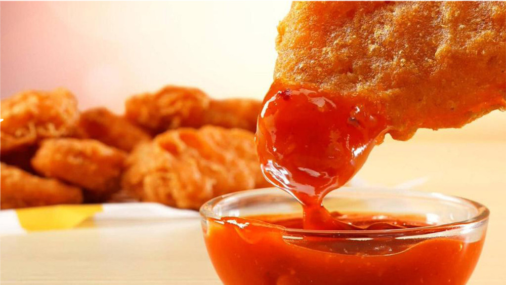 Dipping a Spicy McNugget in sauce