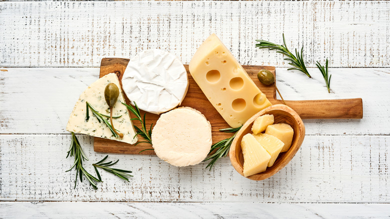 Various cheeses on a cutting board