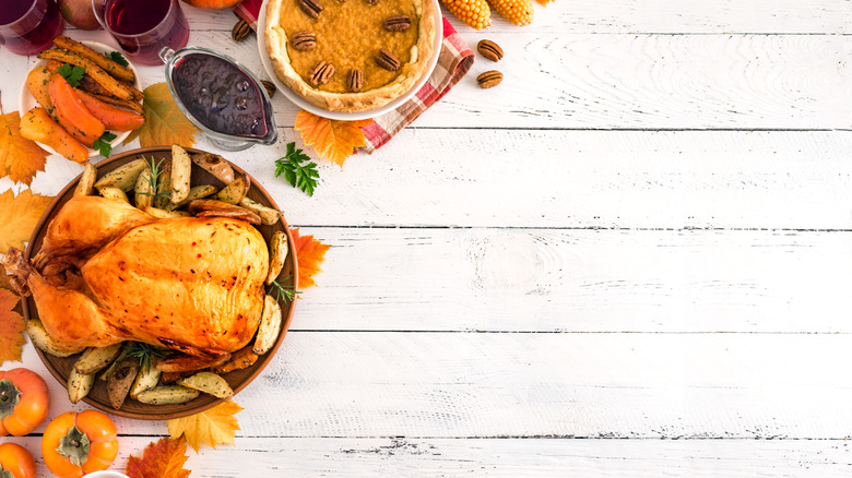 Thanksgiving meal on white wood plank surface 