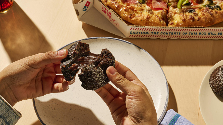 Chocolate lava cake being ripped apart