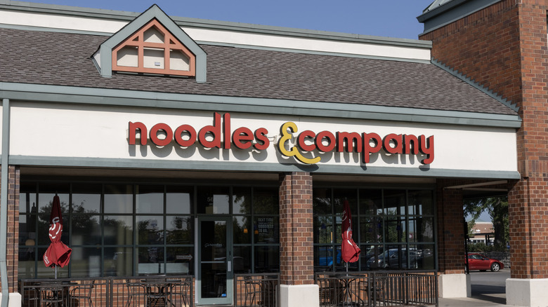 Noodles & Company location, with outdoor seating with umbrellas.