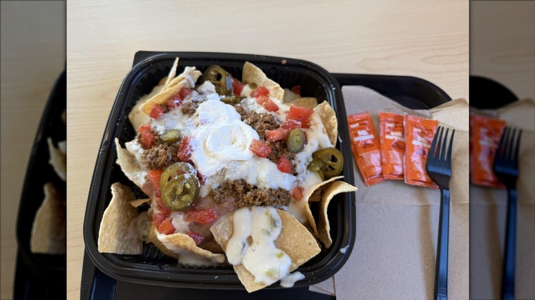 Nachos topped with queso-style sauce, meat, and jalapenos at Del Taco