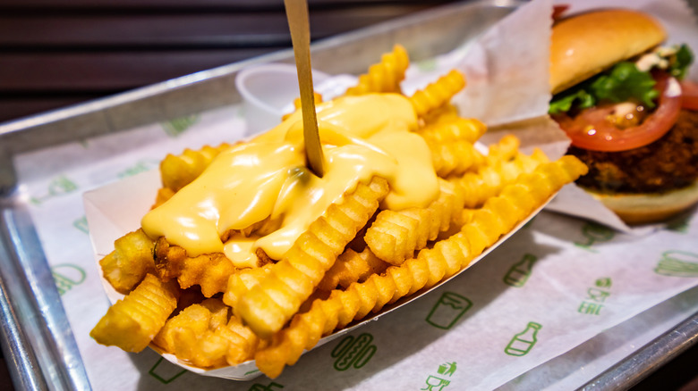 Shake Shack cheese fries next to a burger