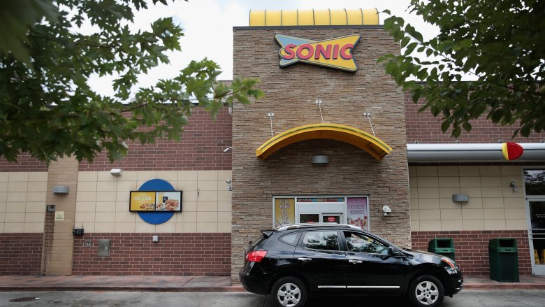 A customer driving through a Sonic
