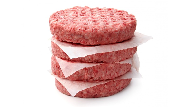 Fresh raw hamburger patties stacked