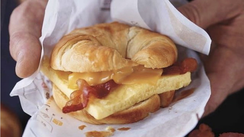 Person holding a Burger King Croissan'wich
