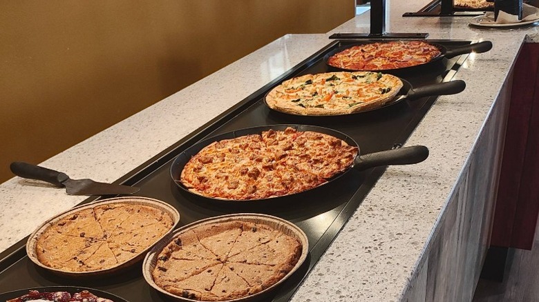 A Pizza Ranch pizza buffet with several pies laid out