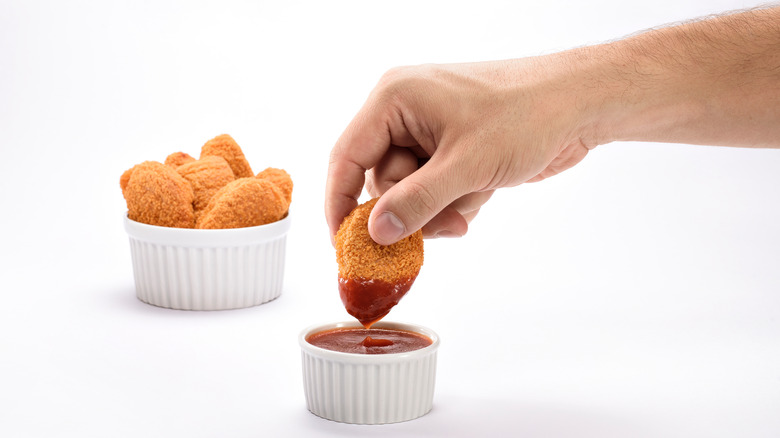 Dipping a nugget in sauce