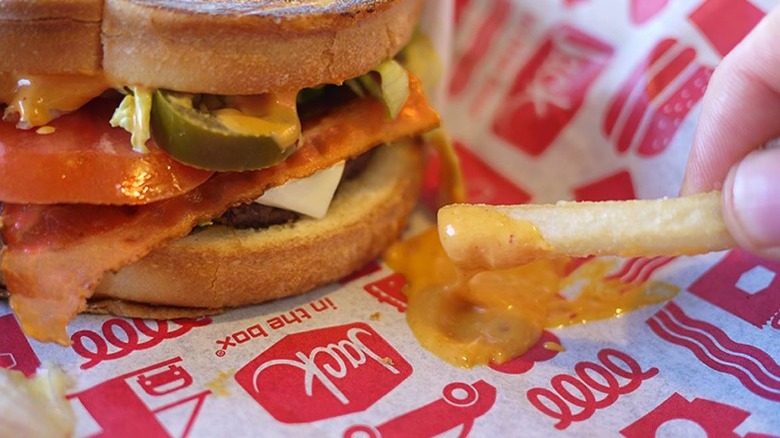 Jack in the box sandwich with sauce and fries