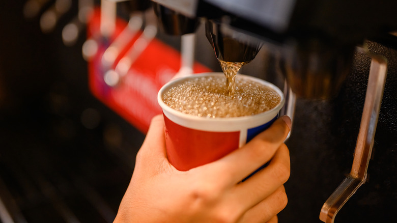 hand refilling fast food drink cup
