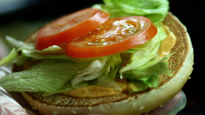 burger toppings on half of bun