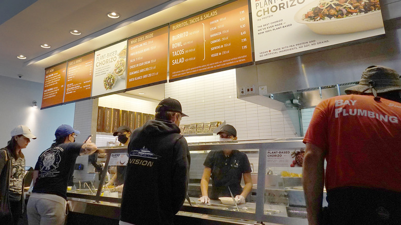 Chipotle workers making bowls