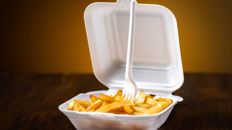 French fries in a container with a fork