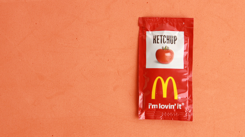 McDonald's ketchup packet on an orange background