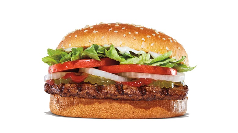 A Whopper from Burger King with toppings and a sesame seed bun.