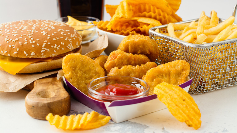 Fast food burger, nuggets, chips, and fries