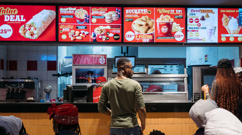 man ordering from chicken restaurant