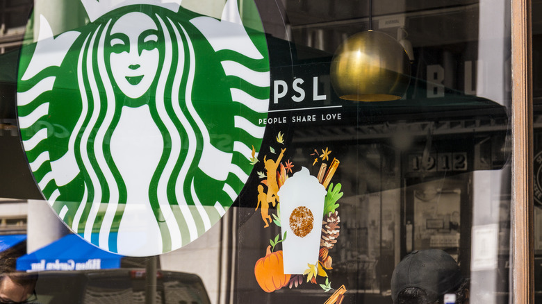 Starbucks window display promoting Pumpkin Spice Latte