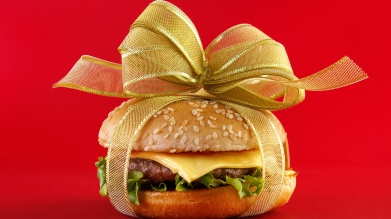 Cheeseburger wrapped in gold bow