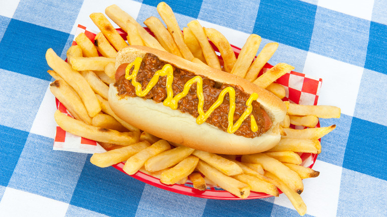 Hot dog in basket of fries